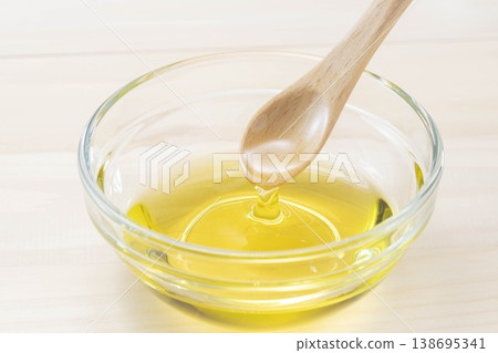 A wooden spoon for pouring olive oil 138695341