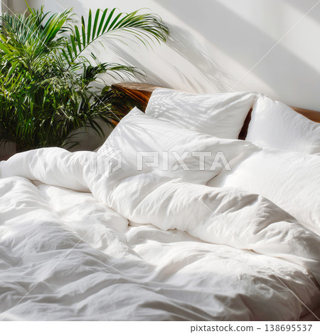 Cozy Sunlit Bed with Green Plant 138695537