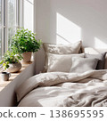 Cozy Bed with Potted Plant by Sunlit Window 138695595