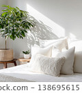 Bright bedroom with white bedding and plant decor 138695615