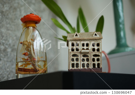 Decorative glass bottle and miniature house stylish interior shelf objects 138696047