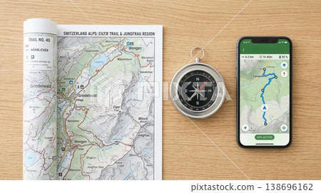 Overhead view of hiking map, traditional compass, and modern smartphone planning mountain adventure. 138696162