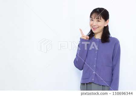 A woman pointing with a smile A woman pointing with a smile 138696344