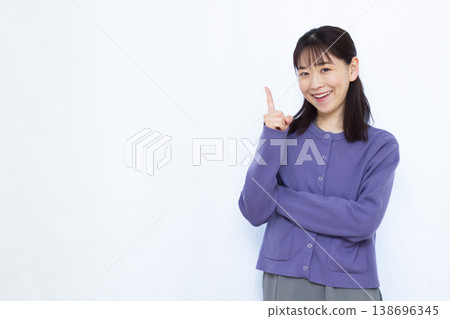 A woman pointing with a smile A woman pointing with a smile 138696345