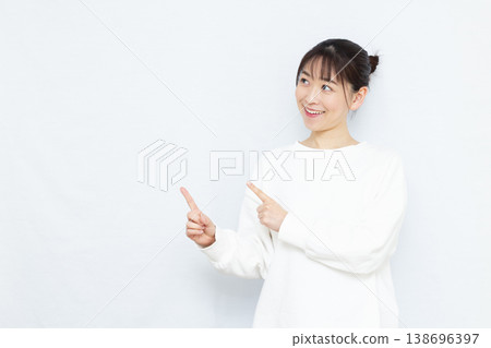 一位女士微笑著指著什麼。 138696397