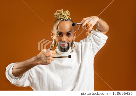African american gay with make up brush isolated African american gay with make up brush isolated 138696425