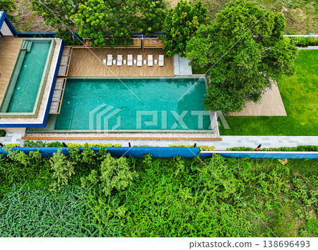 Swimming pool blue water and green grass in summer top view angle. Aerial view images of swimming pool in a sunny day 138696493