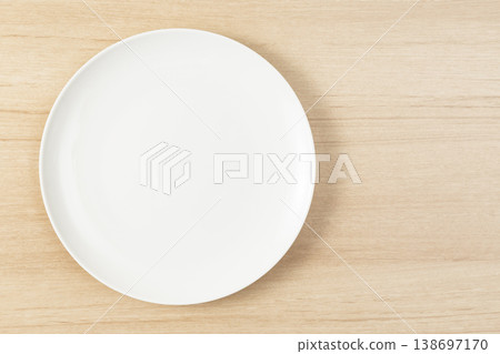 White plate placed on the table White plate placed on the table 138697170