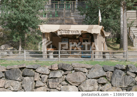 A traditional tent with a "RANGER CAMP" sign stands amidst nature. 138697503