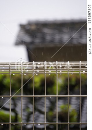 On a rainy day, raindrops on the fence look like jewels. On a rainy day, raindrops on the fence look like jewels. 138697805
