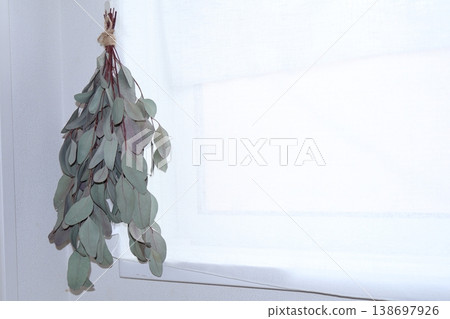 A eucalyptus swag and white curtains adorning the windowsill. A eucalyptus swag and white curtains adorning the windowsill. 138697926