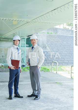 Portrait of an engineer wearing a helmet Portrait of an engineer wearing a helmet 138697991