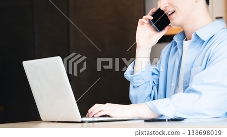 A young businessman talking on his smartphone A young businessman talking on his smartphone 138698019