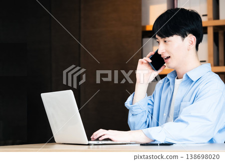 A young businessman talking on his smartphone A young businessman talking on his smartphone 138698020