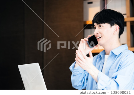 A young businessman talking on his smartphone A young businessman talking on his smartphone 138698021