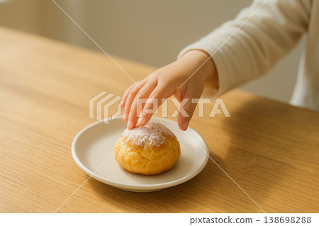A child reaching for a cream puff A child reaching for a cream puff 138698288
