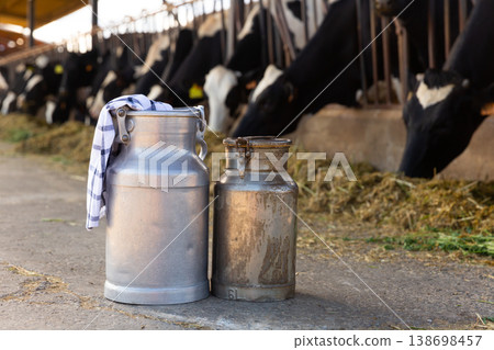 Image of two milk canisters standing on a farm Image of two milk canisters standing on a farm 138698457