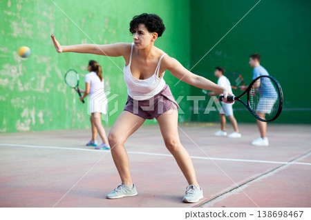 Woman playing frontenis on outdoor pelota court 138698467