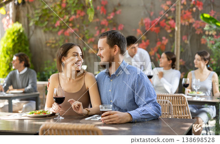 Couple man and woman eating and talking in restaurant Couple man and woman eating and talking in restaurant 138698528