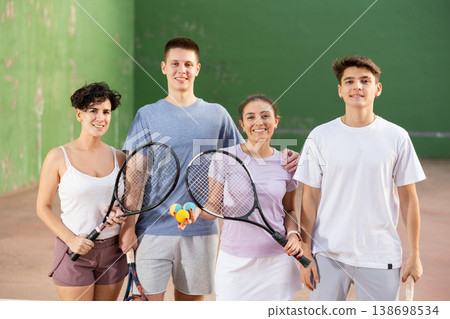 Group photo of positive young men and women standing on frontenis court after game 138698534
