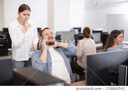 Female teacher makes remark to man student, asks to stop talking on phone during lesson Female teacher makes remark to man student, asks to stop talking on phone during lesson 138698541