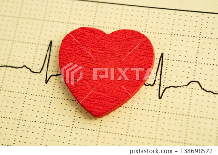 Red heart on electrocardiogram ECG with red heart, heart wave, heart attack, cardiogram report. Red heart on electrocardiogram ECG with red heart, heart wave, heart attack, cardiogram report. 138698572