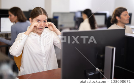 Young woman with tired eyes from working at computer 138698671
