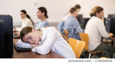 Young woman fell asleep at table in office Young woman fell asleep at table in office 138698698