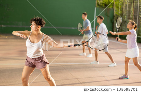 Woman serving ball during frontenis game outdoors 138698701