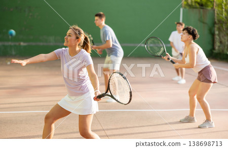 Woman playing frontenis on outdoor pelota court 138698713