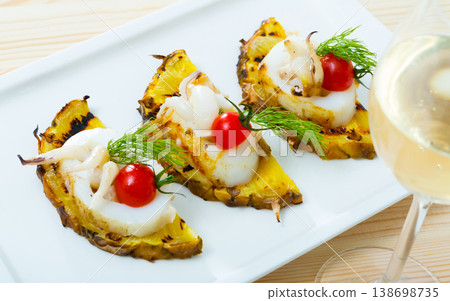 Sepia fried on a grill with pineapple and cherry tomatoes is tasty dish 138698735