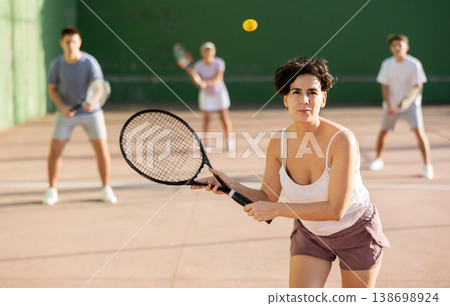 Young Argentinian woman playing frontenis at open-air fronton in summer Young Argentinian woman playing frontenis at open-air fronton in summer 138698924