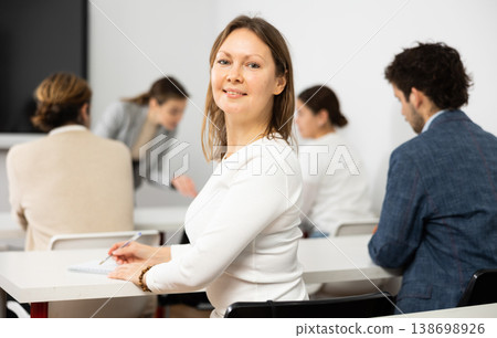 Diligent adult woman attending lecture in university Diligent adult woman attending lecture in university 138698926