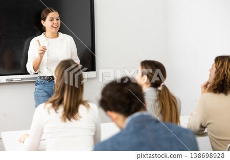 Young female teacher giving lecture to group of student Young female teacher giving lecture to group of student 138698928