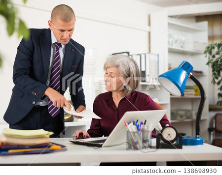 Two business colleagues working with laptop and papers in office Two business colleagues working with laptop and papers in office 138698930