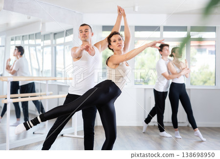 Young man and adult woman rehearsing pair ballet Young man and adult woman rehearsing pair ballet 138698950