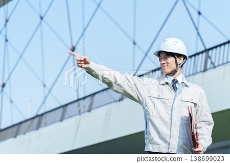 A portrait of a civil engineer looking up at the sky. A portrait of a civil engineer looking up at the sky. 138699023