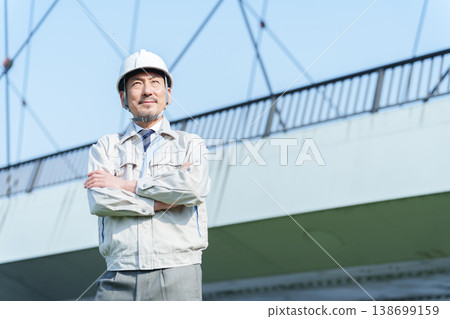 A civil engineer with his arms crossed. A civil engineer with his arms crossed. 138699159