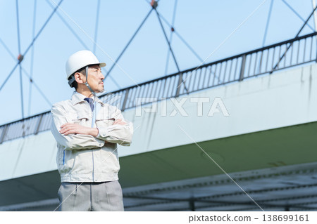 A civil engineer with his arms crossed. A civil engineer with his arms crossed. 138699161