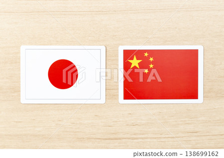 Japanese and Chinese flags placed on the table Japanese and Chinese flags placed on the table 138699162