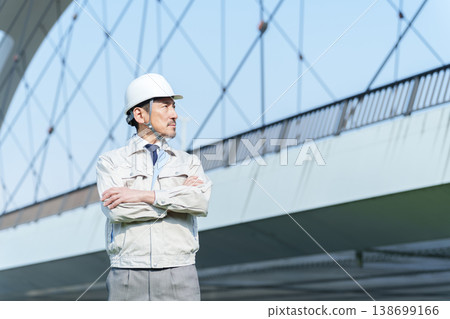A civil engineer with his arms crossed. A civil engineer with his arms crossed. 138699166