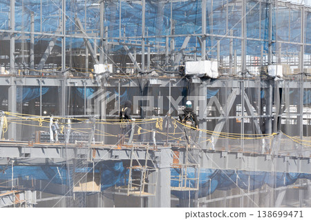Workers performing work at heights at a steel frame construction site and safety net 4 138699471