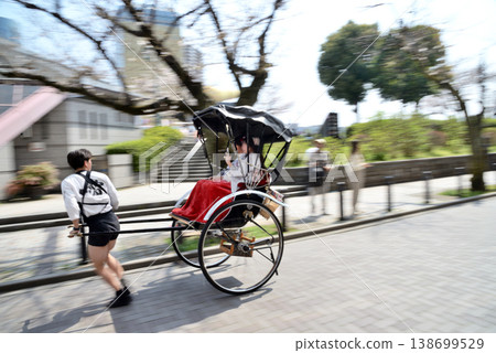 Rickshaw running along Sumida River Sukeroku Yume Dori with cherry blossoms in full bloom 138699529