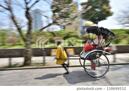 Rickshaw running along Sumida River Sukeroku Yume Dori with cherry blossoms in full bloom 138699532