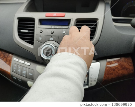 The driver's hand adjusting the car's gears The driver's hand adjusting the car's gears 138699950