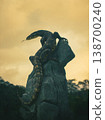 Large monitor lizard perches atop a weathered stone 138700240