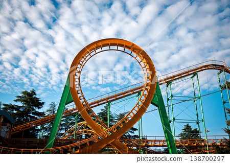Dramatic low angle of a roller coaster loop with fluffy altocumulus clouds Dramatic low angle of a roller coaster loop with fluffy altocumulus clouds 138700297