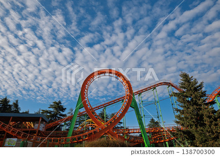 Dramatic low angle of a roller coaster loop with fluffy altocumulus clouds Dramatic low angle of a roller coaster loop with fluffy altocumulus clouds 138700300