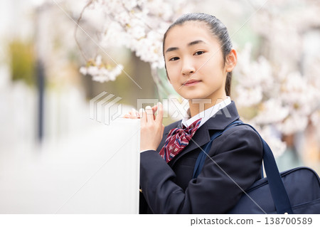 A student, a high school girl, walking under the cherry blossoms. 138700589