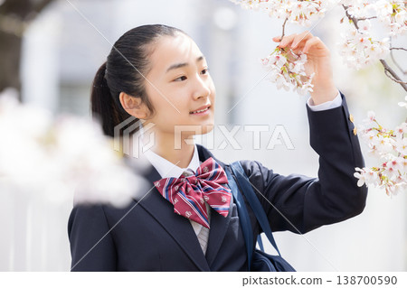 A student, a high school girl, walking under the cherry blossoms. 138700590